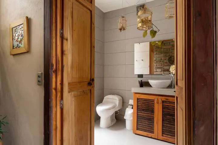 Baño con mueble de madera y lavamanos